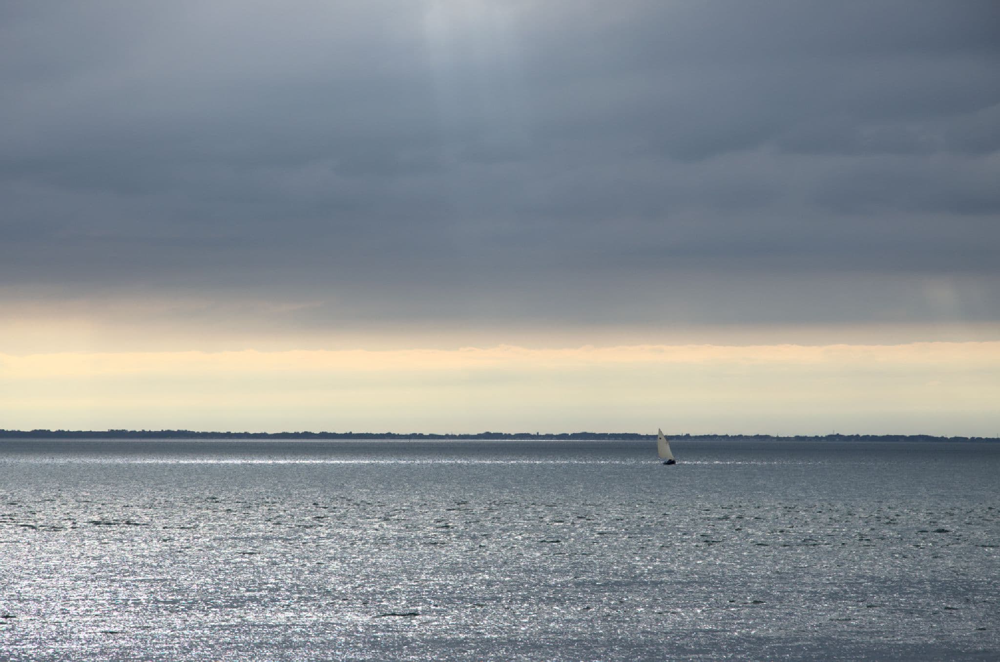 A small boat sailing in the light